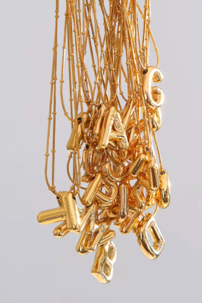 pendentif initiale acier inoxydable doré