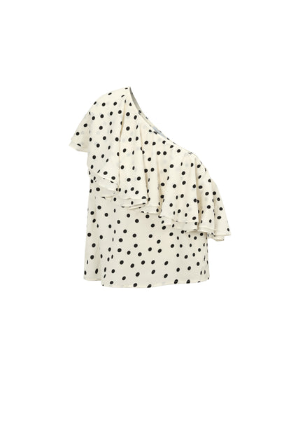 Haut one-shoulder pois blanc crème fond noir flatlay