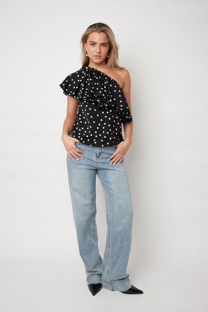 Look complet haut asymétrique pois noir volants jean